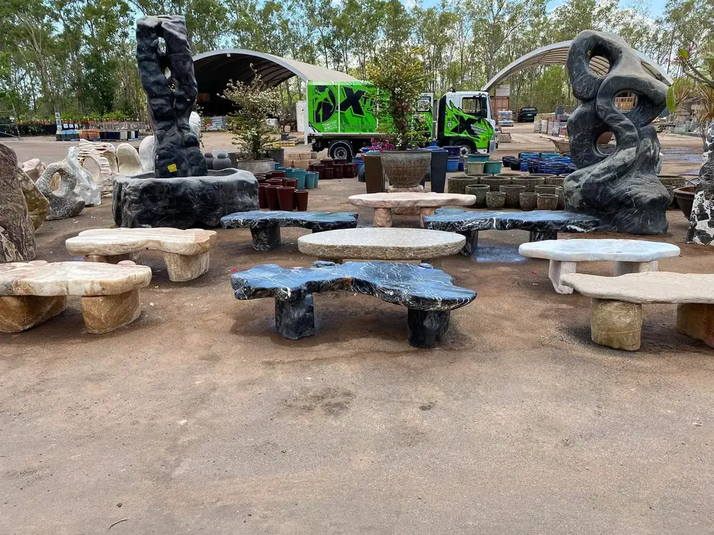 Stone benches and garden features displayed in the Finlay's Stone yard