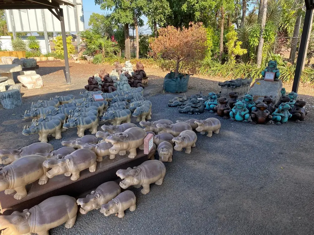 Rows of carved stone animal garden ornaments