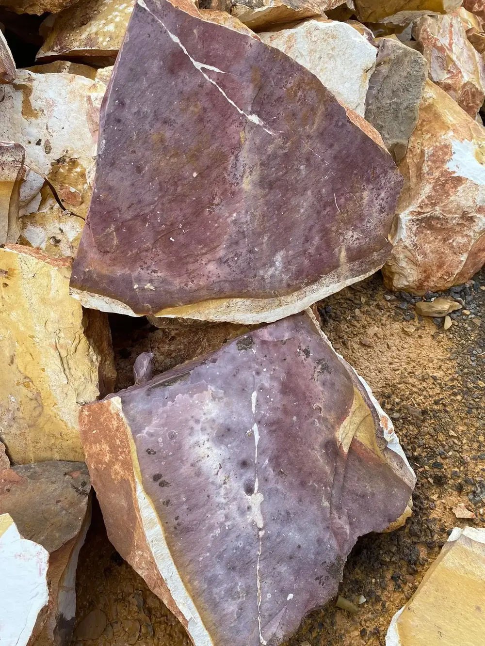 Raw natural stone showing purple and brown colour variation