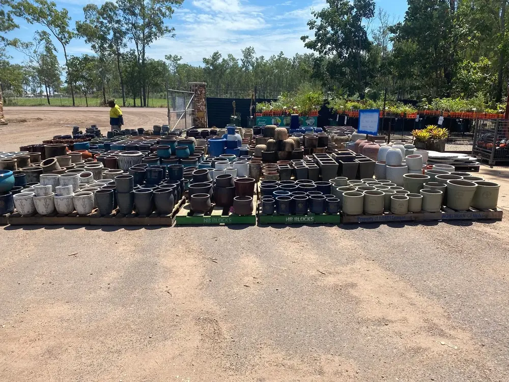 Rows of garden pots displayed across the Finlay's Stone yard