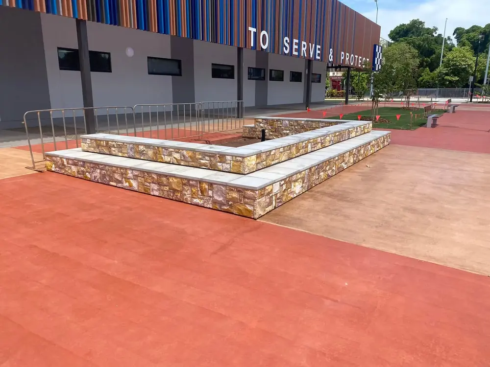 Completed stone-clad retaining and seating feature built with natural stone