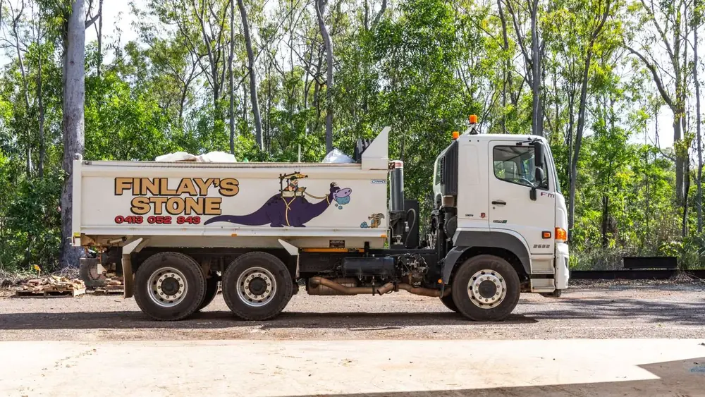 Finlay's Stone delivery truck beside the landscape supply yard