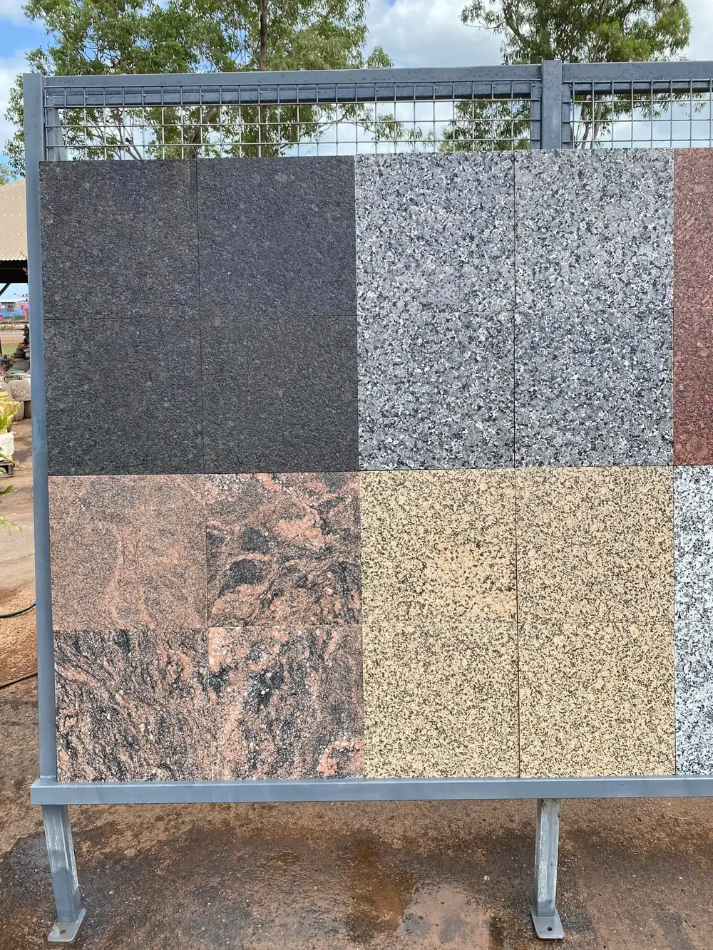 Paver colour and stone samples displayed on a rack