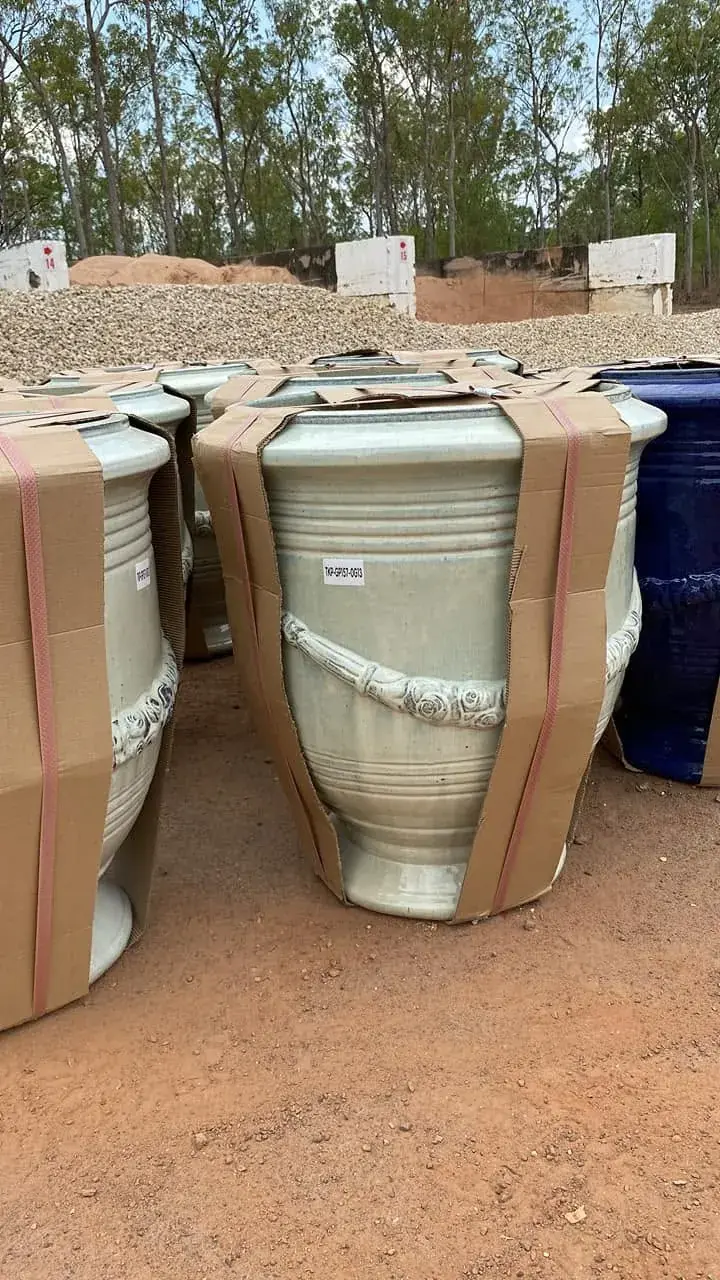 Large glazed garden pots displayed in the yard