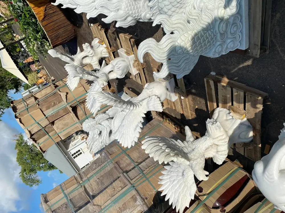 White carved stone dragon sculptures showing detailed stone craftsmanship