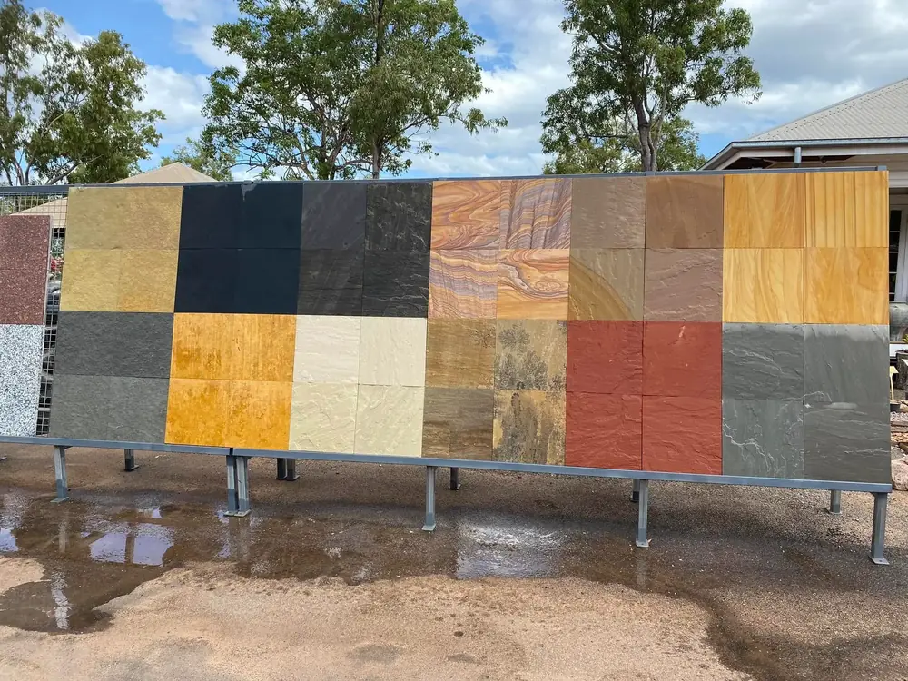 Natural stone paver samples arranged on a display wall