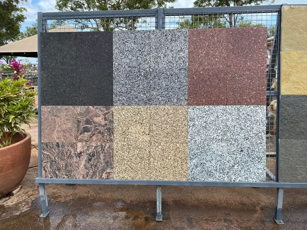 Granite and stone paver samples displayed in the yard