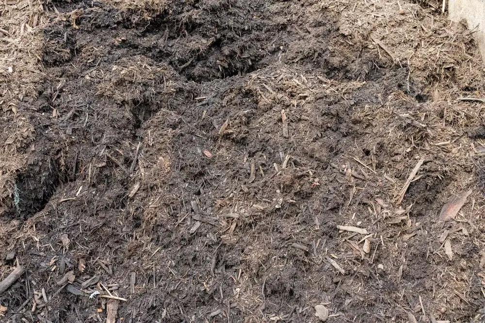 Dark composted mulch material in the Finlay's Stone yard