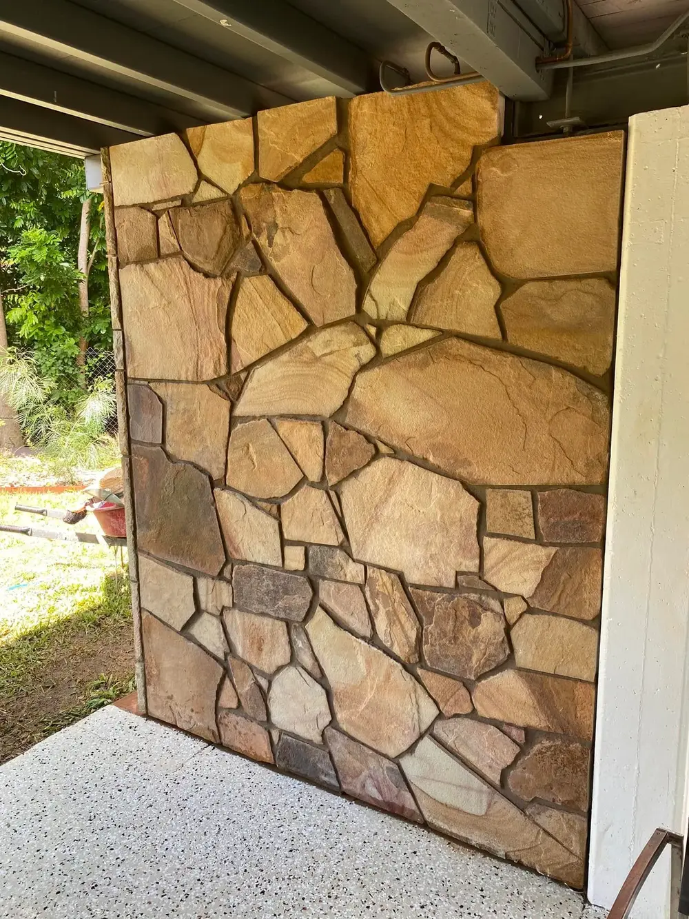 Installed natural stone feature wall in warm earthy tones