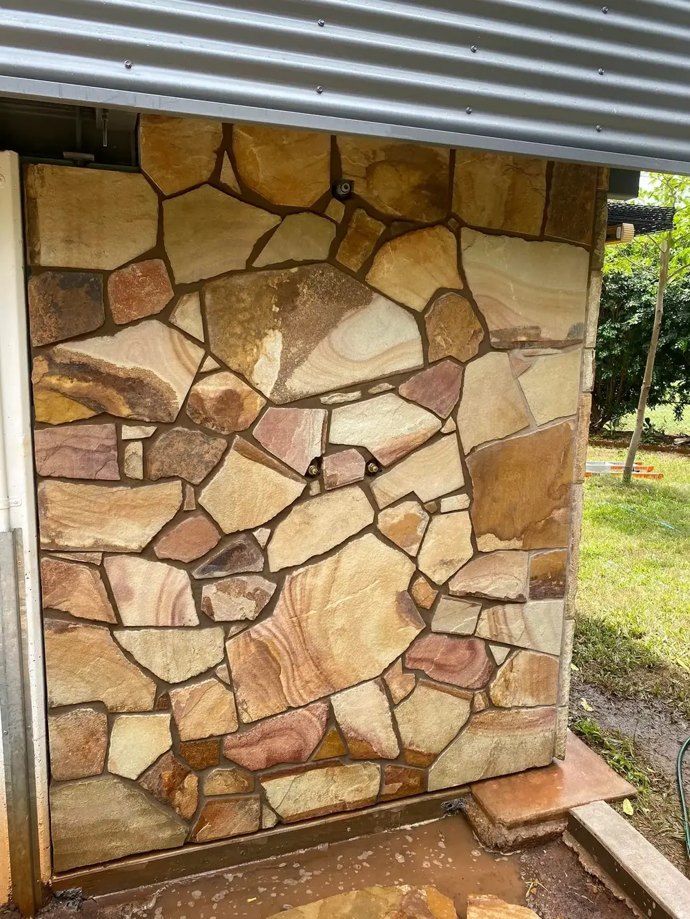 Close view of an installed irregular natural stone wall