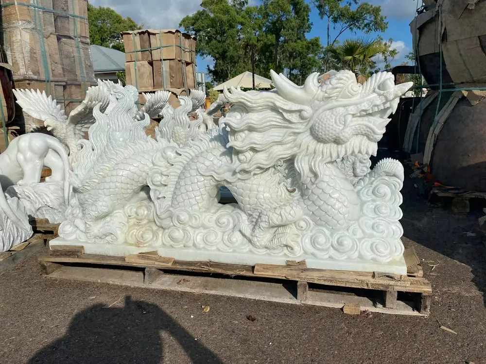 Pair of detailed white stone dragon sculptures