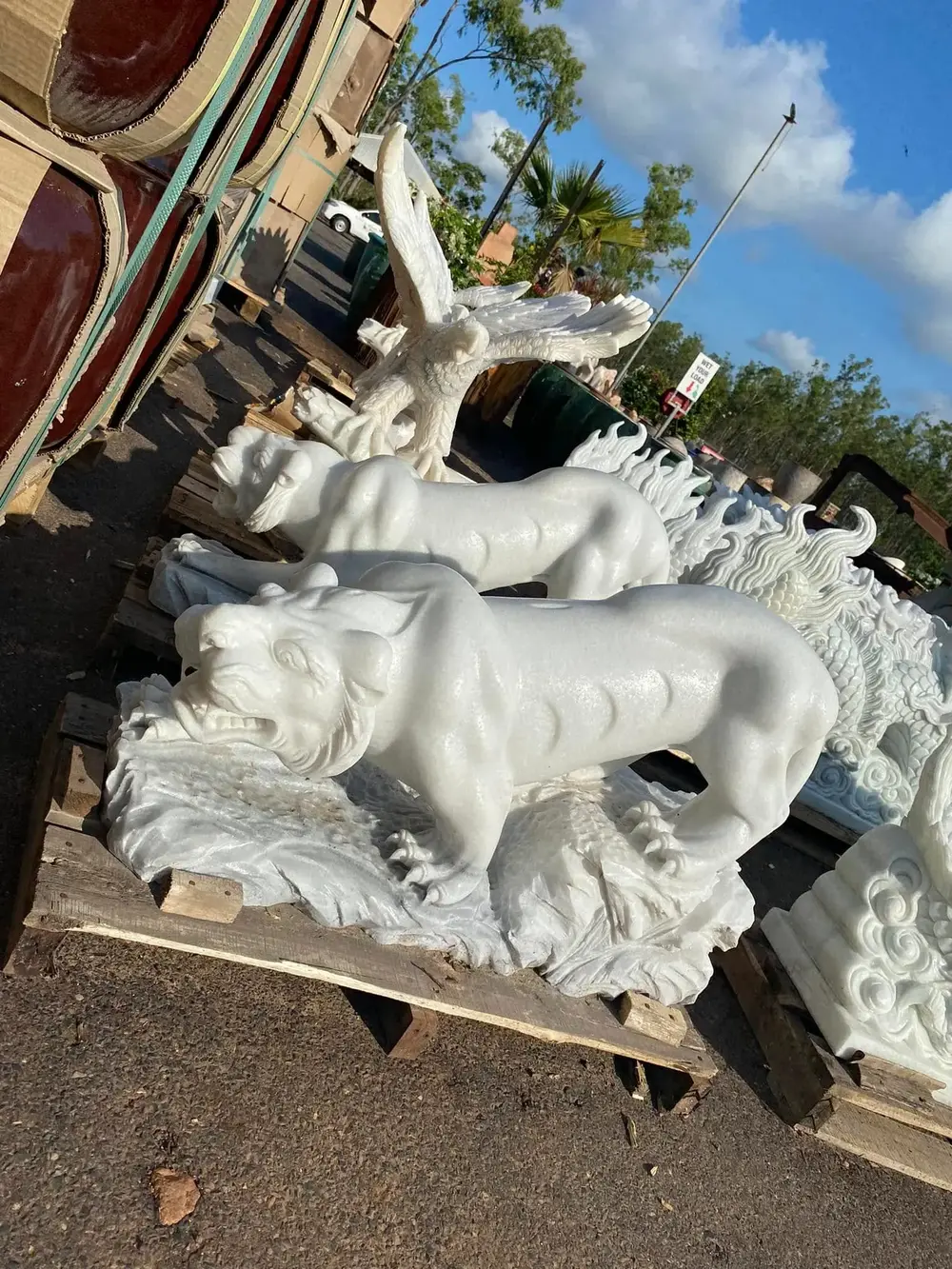 Carved white stone garden sculpture showing detailed masonry work